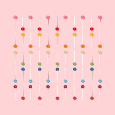 colorful lollipops on a pastel pink background